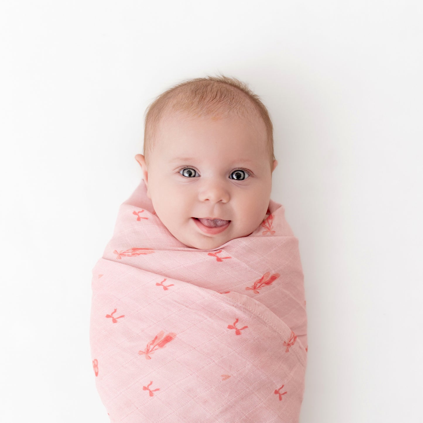 baby wrapped in bamboo muslin swaddle with ballerina print