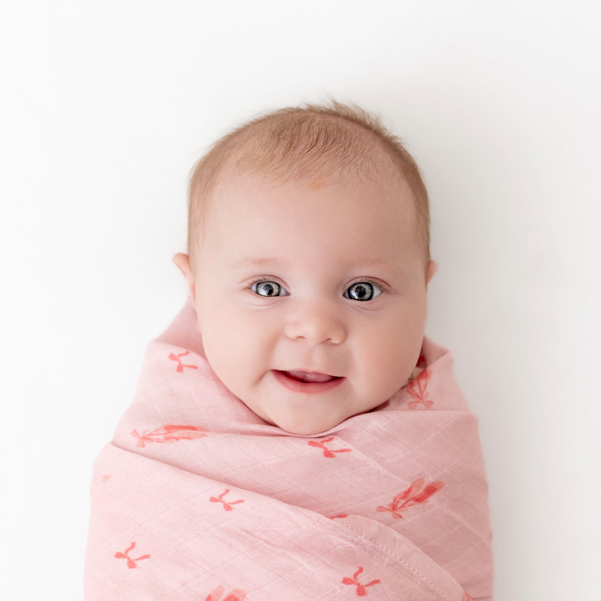 baby wrapped in ballerina muslin bamboo swaddle