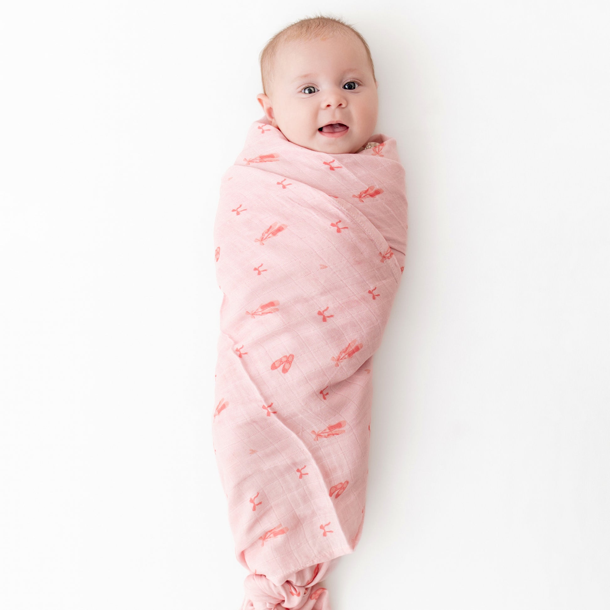 soft bamboo muslin swaddle wit ballerina print on pink background