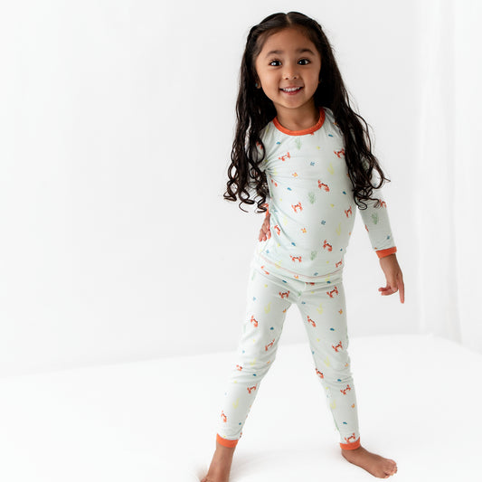 Toddler wearing long sleeve bamboo pajama set in crab print