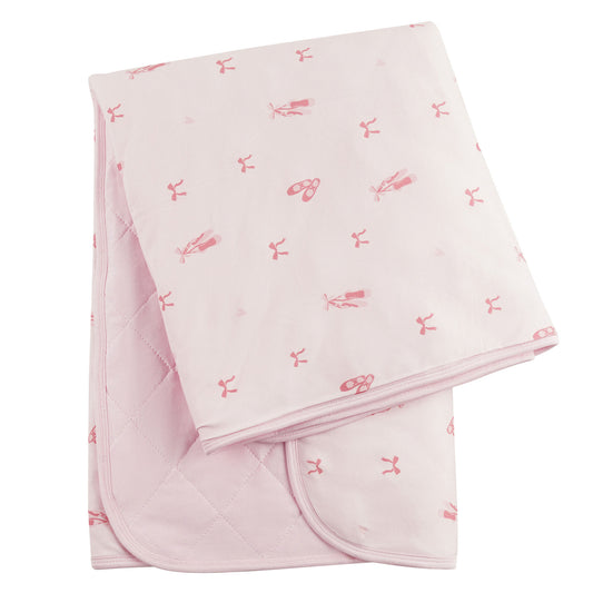 A pink baby blanket with a ballerina and ballet slipper pattern