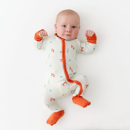 baby wearing convertible romper with crab pattern