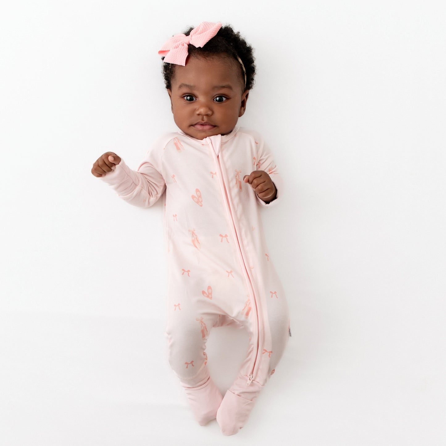 baby in pink ballerina romper with fold over feet