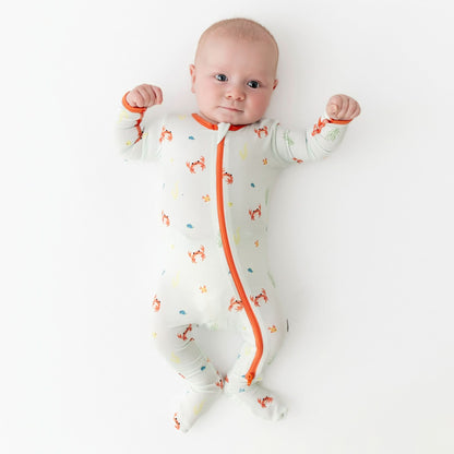 Baby wearing bamboo footie with crab print, front view